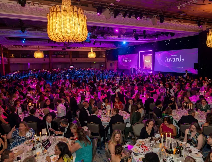 Awards ceremony with people sitting at round tables